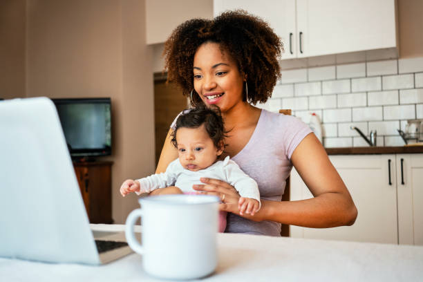 istock Mother and daughter using laptop at home 1147534676