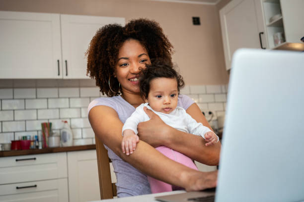 istock Mother and daughter using laptop at home 1147534736