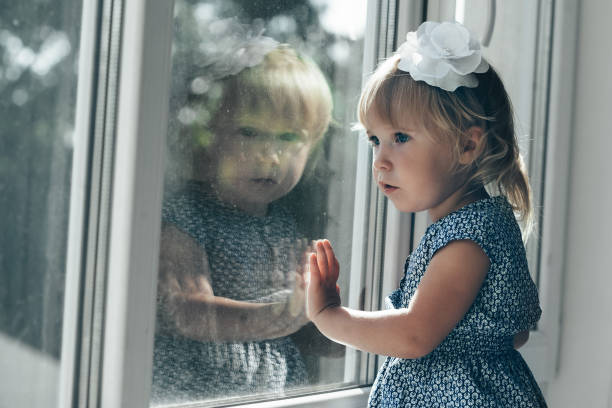 istock the child is looking in the spring window 1147538295