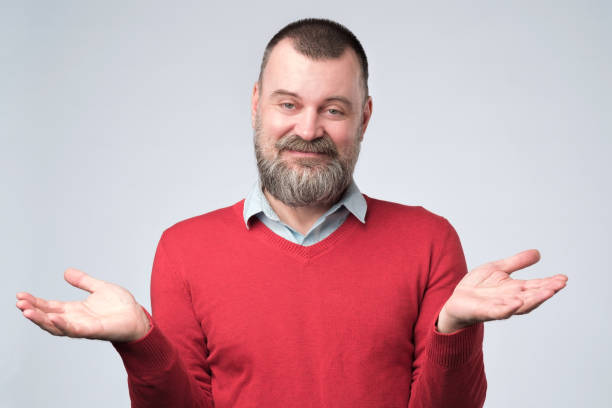 man showing i have no idea gesture, shrugging shoulders and raising hands - blank expression head and shoulders horizontal studio shot imagens e fotografias de stock