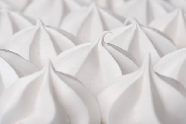 White cream crispy meringues cookies close-up.