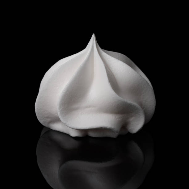 istock White big meringue cookie isolated on black background 1147539943
