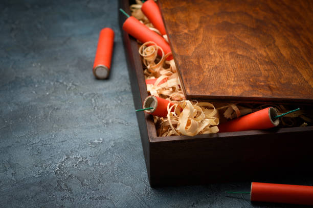 istock Wooden crate with red dynamite firecracker tnt sticks 1147540160