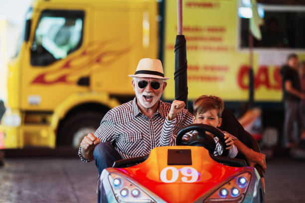 istock Grandfather and grandson amusement park fun 1147540612