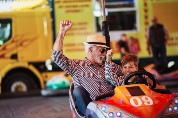 istock Grandfather and grandson amusement park fun 1147540655
