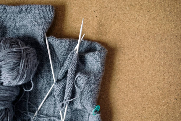 istock Incomplete knitting gray sweater for child with needles 1147542129