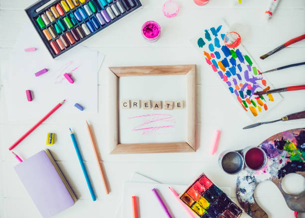 istock Topview creative artist mockup. Blank canvas with Create word lettering with variety of drawing supplies. Art, workshop, painting, drawing, inspiration, craft, creativity concept. Art therapy. Flatlay. 1147542279