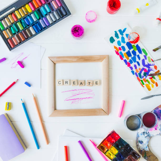 istock Topview creative artist mockup. Blank canvas with Create word lettering with variety of drawing supplies. Art, workshop, painting, drawing, inspiration, craft, creativity concept. Art therapy. Flatlay. 1147542613