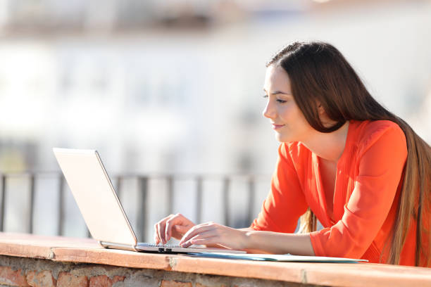 istock Entrepreneur entering data on laptop in a balcony 1147542980