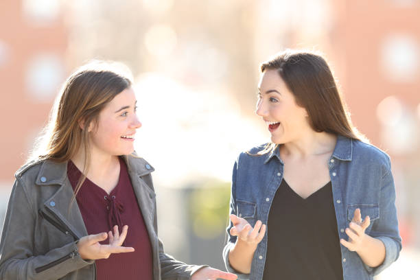 istock Two surprised friends talking in the street 1147543219