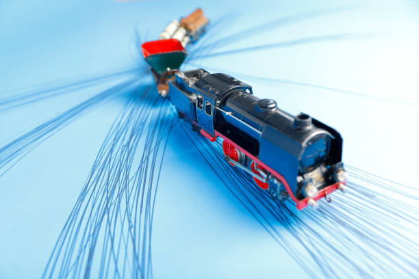 Table top shot with old (1930s) toy train on blue photo carton with hatched lines
