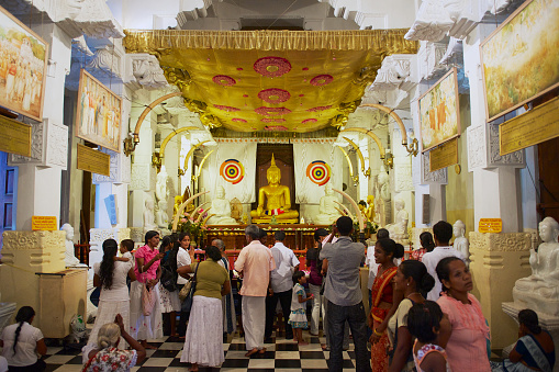 Kandy, Sri Lanka - May 21, 2011: Pilgrims visit Temple of the Tooth (Sri Dalada Maligawa) in Kandy, Sri Lanka.
