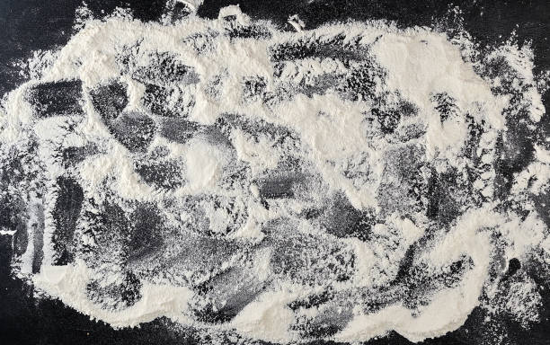 istock white wheat flour scattered on a black background 1147544696