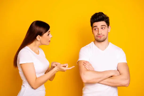 Photo of Close up side profile photo two beautiful people she her he him his blame aggression hands arms crossed folded not listen care lecture scolding wear casual white t-shirts isolated yellow background