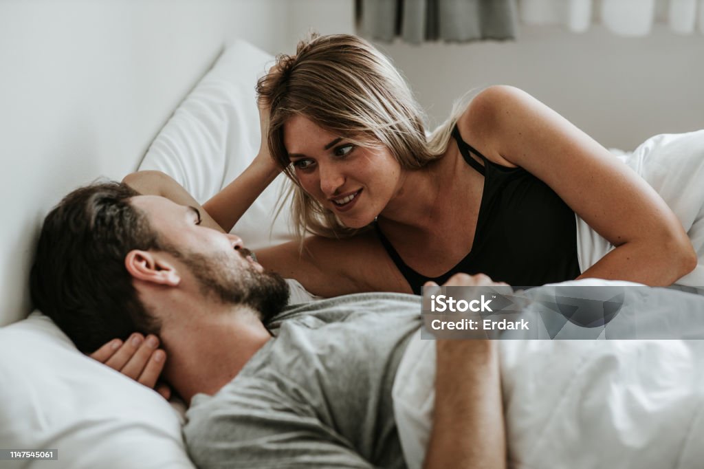 Romantic moment: Happy couple in love in the bed - Stock image Couple - Relationship, Women, Human Sexual Behavior, Waking up, Wife, morning Couple - Relationship Stock Photo