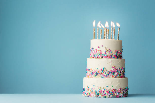 Tiered birthday cake with sprinkles Birthday cake with three tiers and colorful sprinkles cake stock pictures, royalty-free photos & images