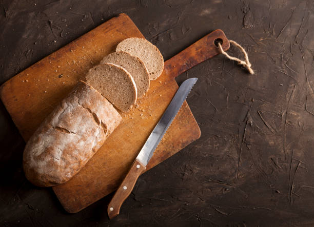 istock Sliced traditional bread and on a dark table 1147550928