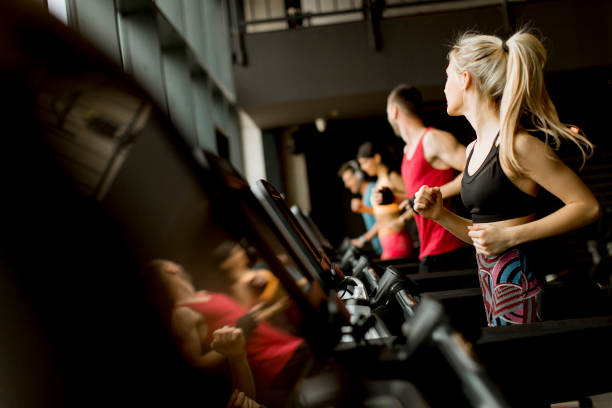 istock young people running on treadmills in modern gym 1147552192