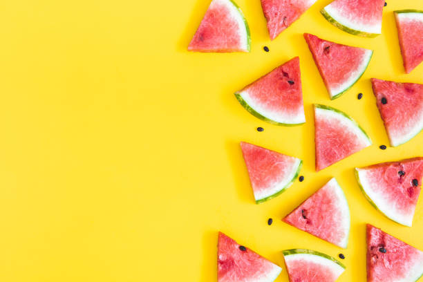 istock Watermelon pattern. Red watermelon on yellow background. Summer concept. Flat lay, top view 1147553057