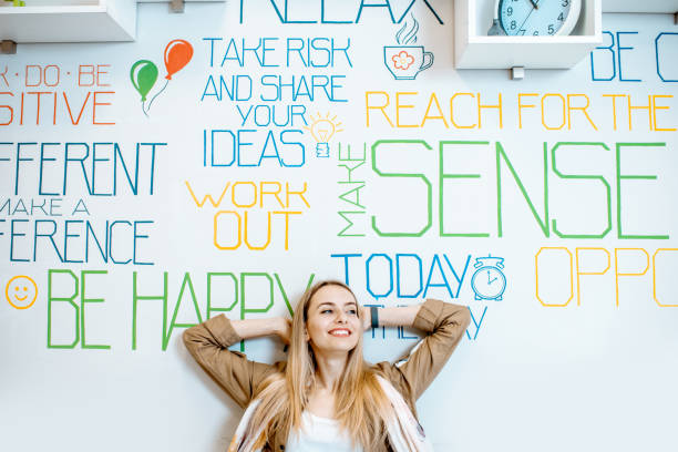 istock Woman on the wall background with various inscriptions 1147553888