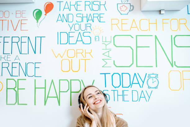 istock Woman on the wall background with various inscriptions 1147553907