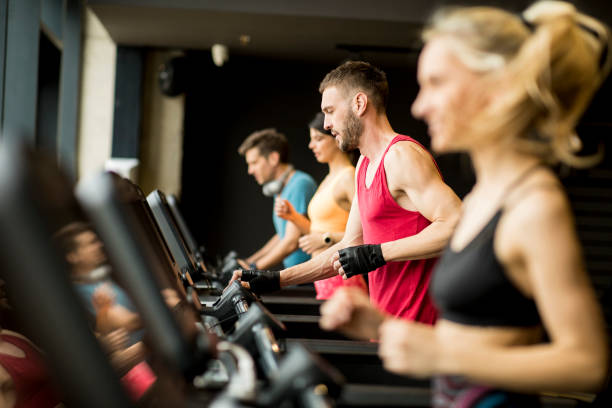istock young people running on treadmills in modern gym 1147553997