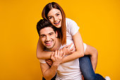 Close-up portrait of his he her she two nice attractive cheerful cheery optimistic people wife husband having fun spare free time isolated over vivid shine bright yellow background