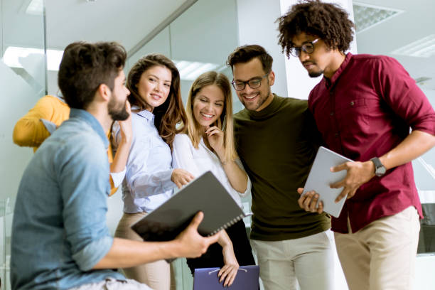 istock Multiracial businesspeople standing and disscusing in modern office 1147554074