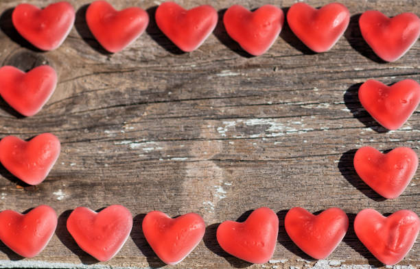 istock wooden background with marmalade hearts 1147554917