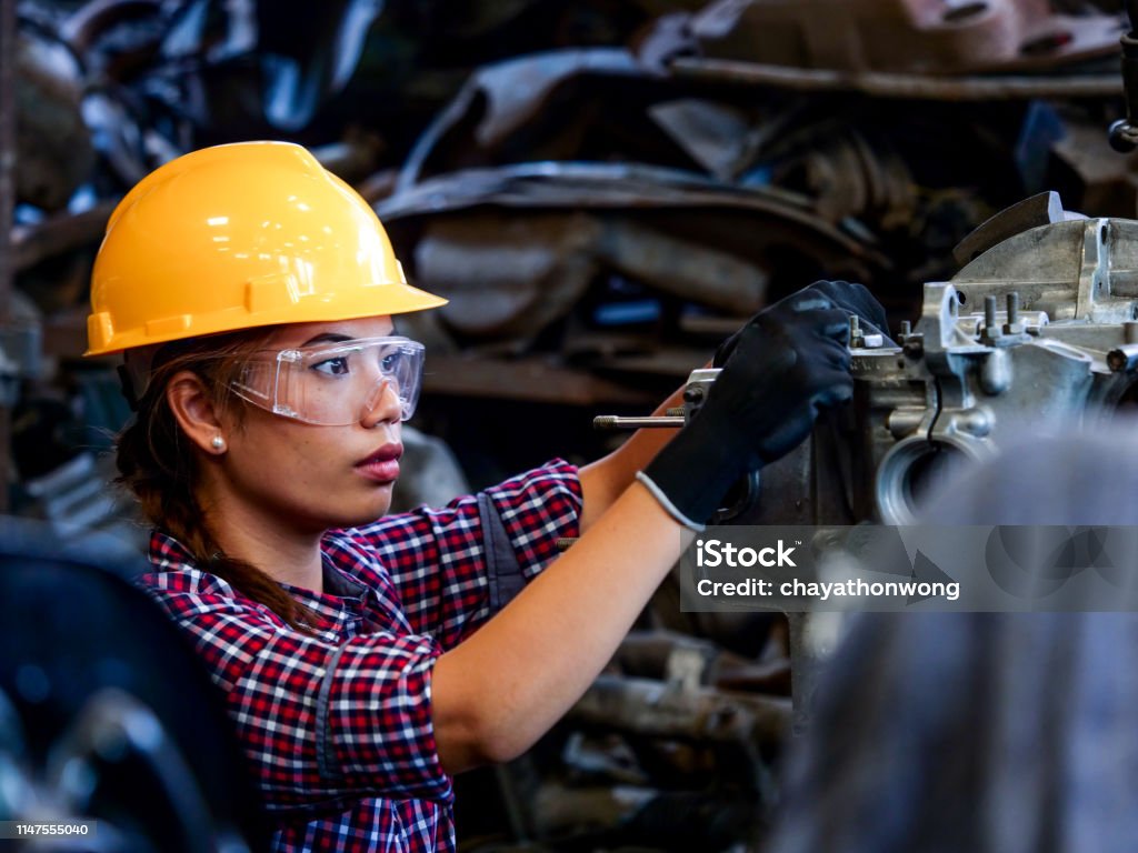 Young Asian Engineer woman Young Asian Engineer woman  working with machine in factory. Engineer Stock Photo