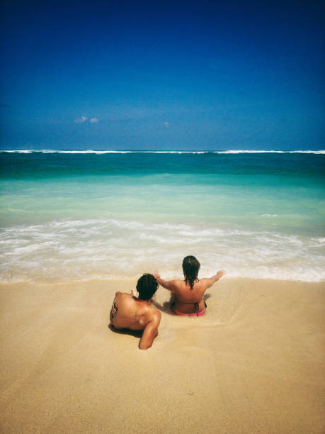 istock Couple enjoying on a sandy ocean tropical beach. 1147557094
