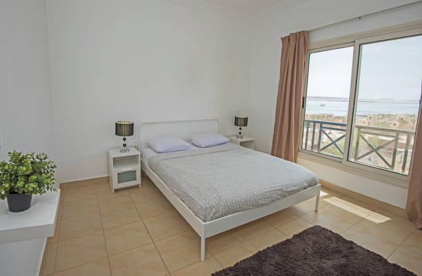 istock Double bed in a luxury apartment with sea view 1147557296
