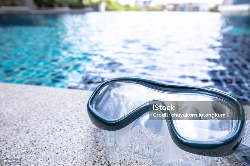 Closeup on Snorkel Mask with swimming pool background. swimming pool gadget, water, mask, snorkel mask, summer Activity Stock Photo