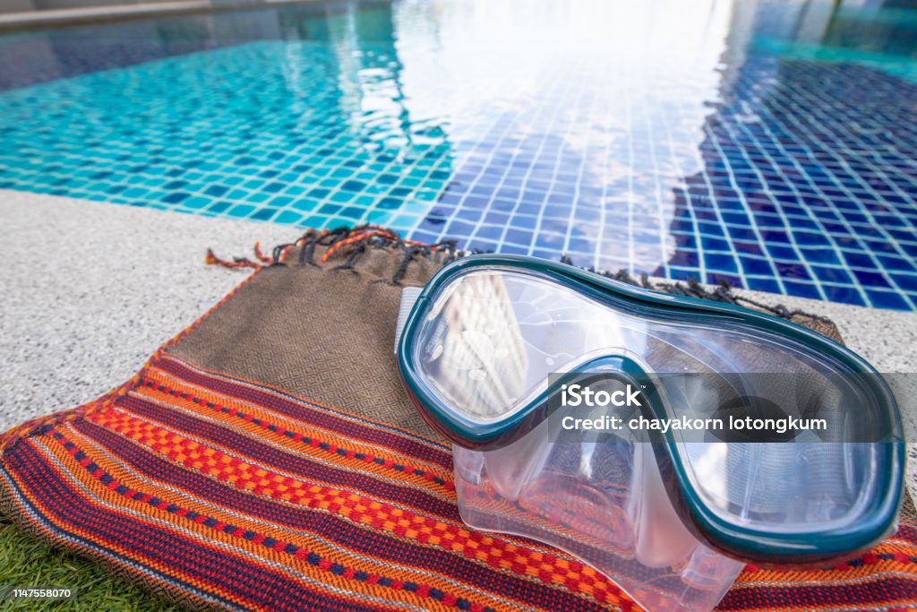 Closeup on Snorkel Mask with swimming pool background. swimming pool gadget, water, mask, snorkel mask, summer Activity Stock Photo