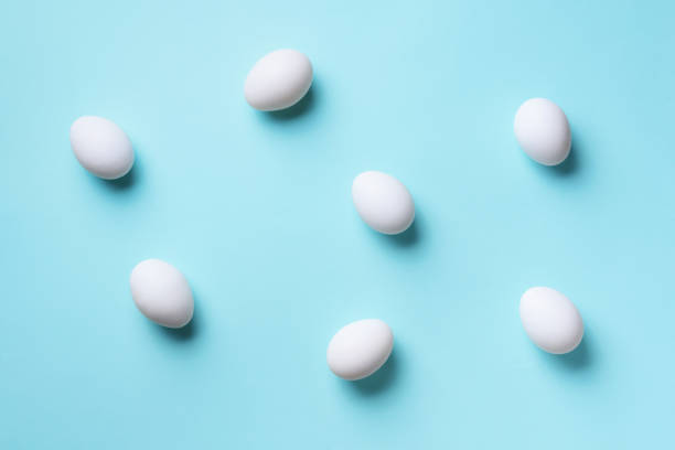 istock Food concept with white chicken eggs on blue background. Top view. Creative pattern in minimal style. Flat lay. 1147558767