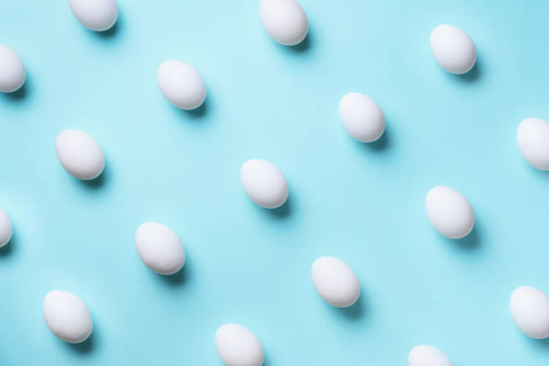istock Food concept with white chicken eggs on blue background. Top view. Creative pattern in minimal style. Flat lay. 1147558791