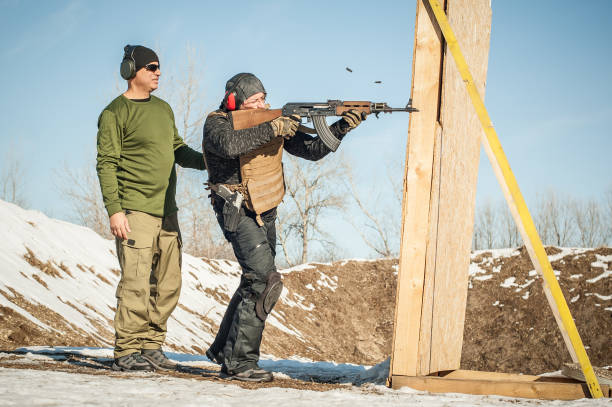 istock Instructor and student had rifle shooting training. Outdoor shooting range 1147559154
