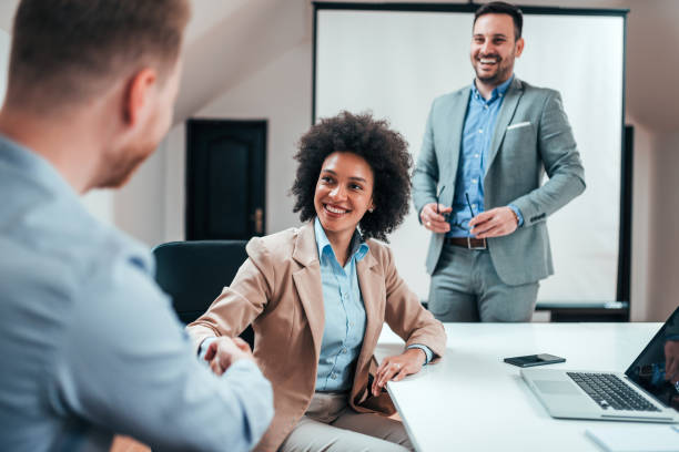 istock Smiling businesswoman shaking partners hand. 1147560619