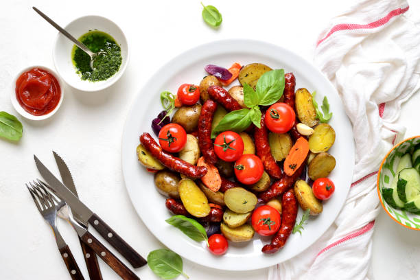 istock Sausages roasted with vegetables, view from above 1147561452