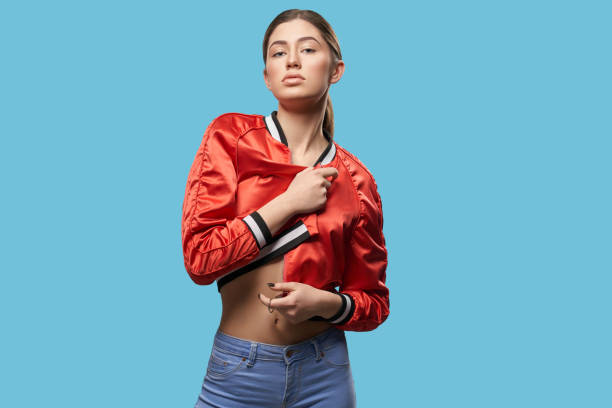 istock Stylish girl in red bright bomber posing in studio. 1147561454