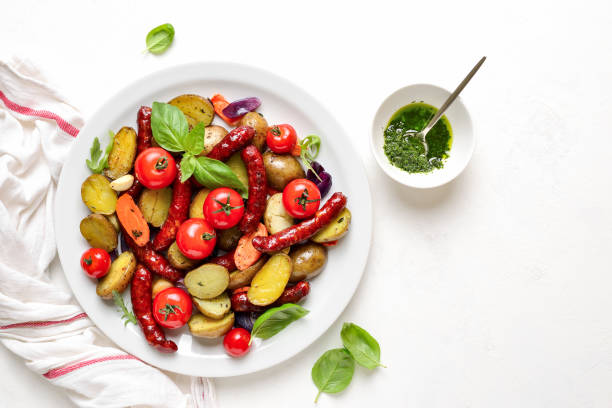 istock Sausages roasted with vegetables, view from above 1147561455
