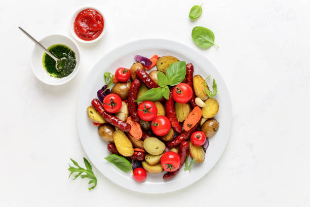 istock Sausages roasted with vegetables, view from above 1147561467