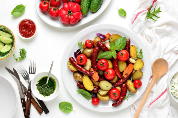 istock Sausages roasted with vegetables, view from above 1147561468