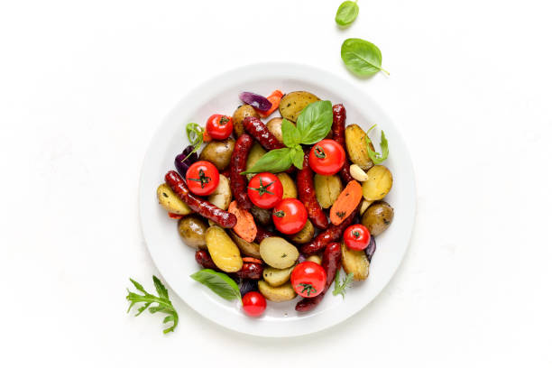 istock Sausages roasted with vegetables, view from above 1147561484