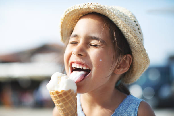 Kids eating ice-cream Kids eating ice-cream licking photos stock pictures, royalty-free photos & images