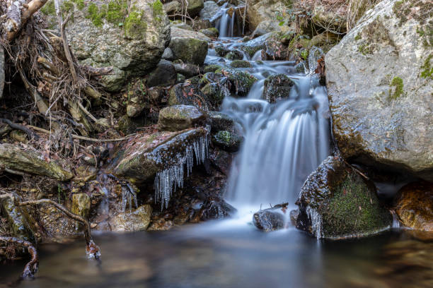 small waterfall in a river near madrid stock photo