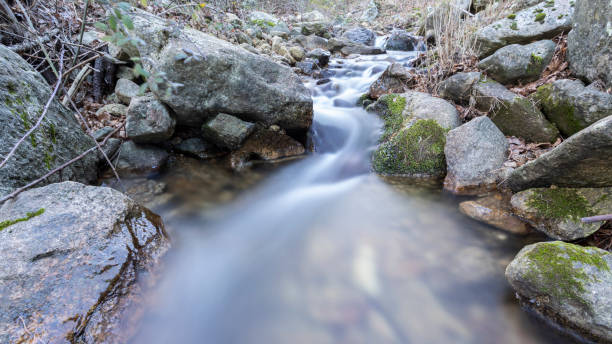 small waterfall in a river near madrid stock photo