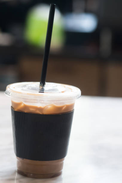 istock Iced coffee with black paper sleeve on table 1147566636