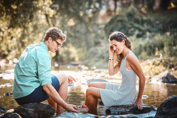 istock Couple have a picnic in stream at sunset 1147566843