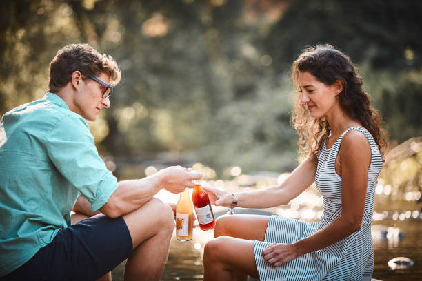 istock Couple have a picnic in stream at sunset 1147567221